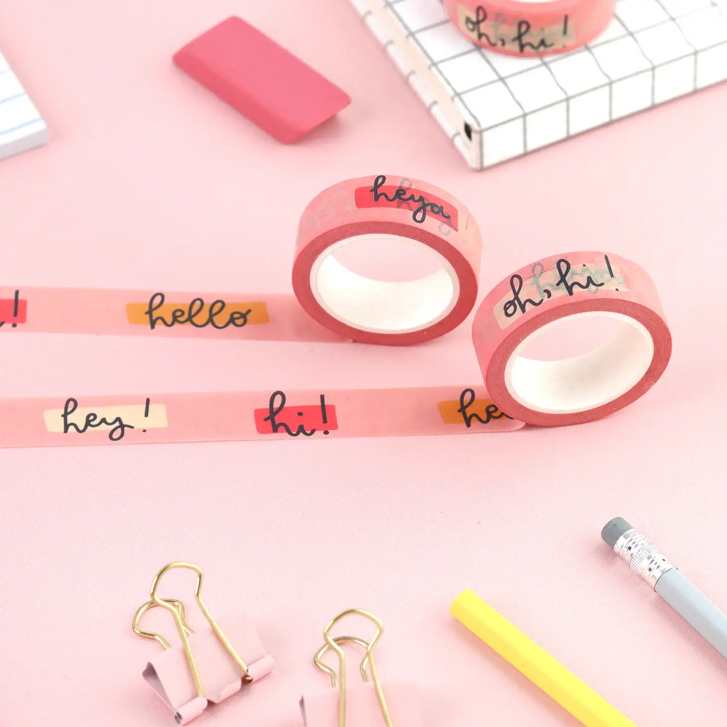 Pink hello washi tape, surrounded by other stationery items